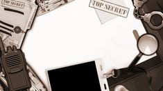 a table topped with lots of assorted items and a sign that says top secret