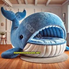a blue whale shaped bed in the middle of a wooden floor