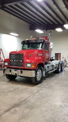 a large red truck parked in a garage