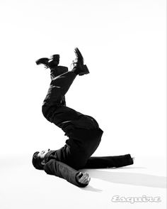 black and white photograph of a man doing a trick