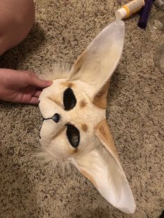 a person is petting a stuffed animal on the floor