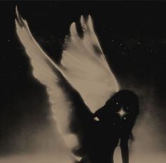 an angel with white wings standing in front of a black and white background at night