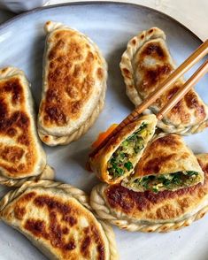 some food is on a plate with chopsticks