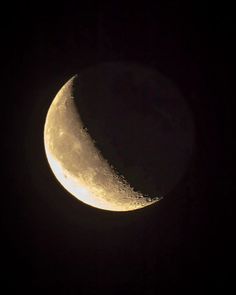 the moon is shining brightly in the dark sky