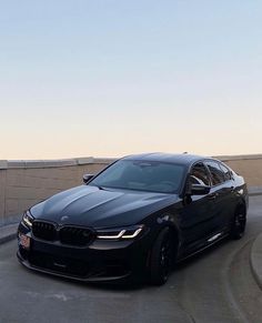 a black car parked on the side of a road