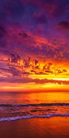 the sun is setting over the ocean with purple and orange clouds