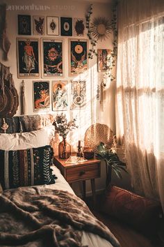 a bed sitting in a bedroom next to a window with pictures on the wall above it