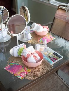 a table topped with lots of personal care items on top of a wooden floor next to a mirror