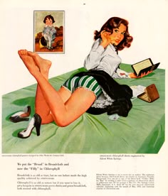 a woman laying on top of a bed next to a book and magazine with her legs crossed