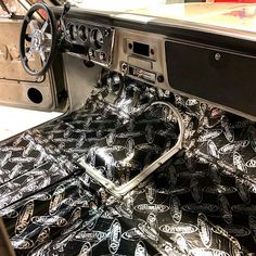 the interior of an old car with black and white designs on it's dashboard