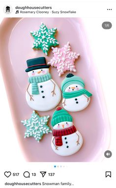 cookies decorated with snowmen and hats on a pink tray