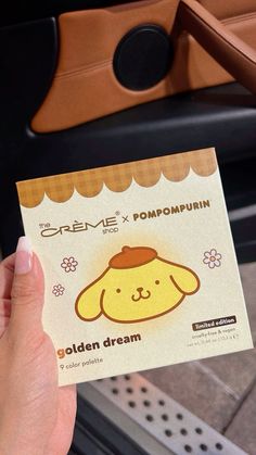 a person holding up a card with a dog on it's face and the words, creme x pompupin golden dream