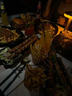 a table filled with lots of different types of food and drinks on top of it
