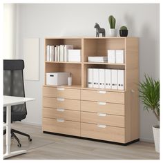 an office with a bookcase, desk and chair
