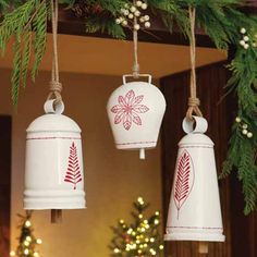 three bells hanging from a christmas tree