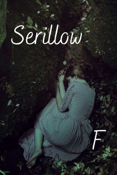 there is a woman sitting in the woods