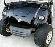 an electric golf cart parked on the street