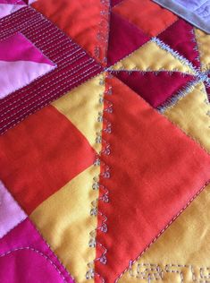 a close up view of a quilted surface with stitching on the edges and stitches