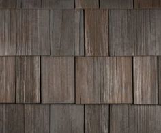 a close up view of the wood shingles on a house's exterior wall