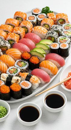 A beautifully arranged sushi platter featuring a variety of colorful sushi rolls, sashimi, and garnishes, ready to be served.