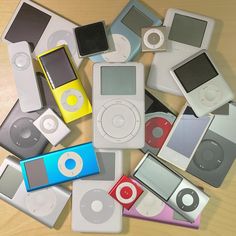 there are many different types of ipods on the table and one is black, white, red, blue, yellow