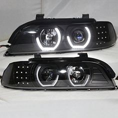 the front and side lights of a black car with chrome trims on white background