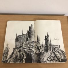 a drawing of hogwart's castle on top of a mountain
