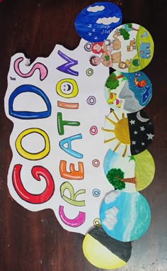 a wooden table topped with lots of different colored paper