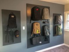 there are many backpacks hanging on the wall