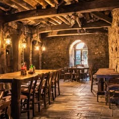 an old stone building with tables and chairs
