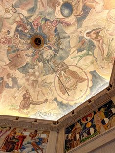the ceiling is painted with many different paintings