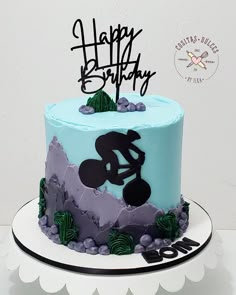 a birthday cake with a dirt bike theme on the top and happy birthday written in black