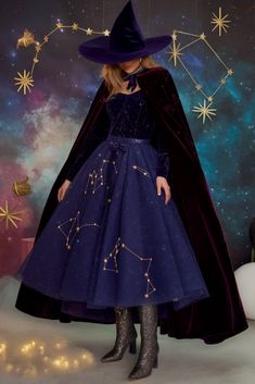 a woman wearing a purple dress and hat with stars in the sky above her head