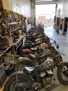many motorcycles are lined up in a garage