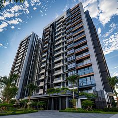 an apartment building with many windows and balconies on the top floor, surrounded by palm trees