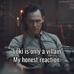 a man sitting at a table in front of a computer with the caption loki is only a villain my honest reaction