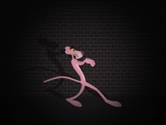 a pink cat running across a brick wall in the dark with its shadow on it