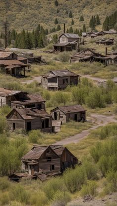 an old, run down town with lots of houses in the grass and trees around it