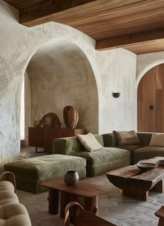 a living room filled with lots of furniture and walls covered in wood planks on the ceiling