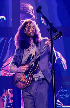 a man with long hair playing a guitar