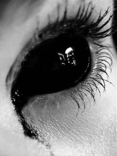 an eye with the words, the monster on it's irise and eyelashes