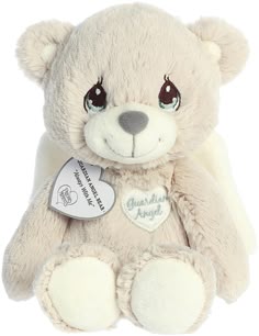 a white teddy bear with a tag on it's chest and eyes, sitting in front of a white background