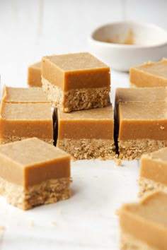 several pieces of peanut butter fudge on a white surface