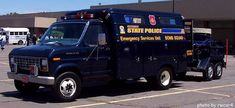 a state police garbage truck parked in a parking lot