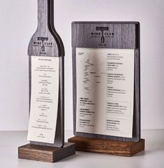 a wine bottle and menu stand on a table