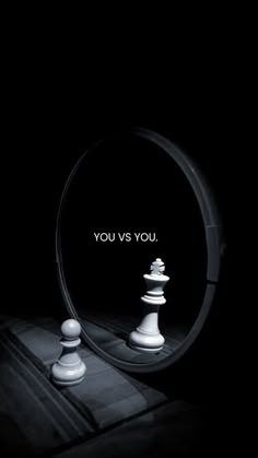 a mirror with the words you vs you on it and chess pieces in front of it