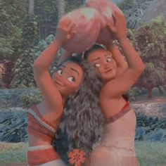 two women are holding a pink object in their hands