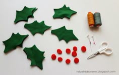 felt christmas decorations and sewing supplies laid out on a table
