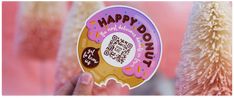 a person holding up a happy donut sticker