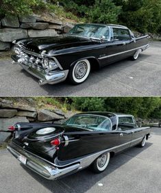 an old black car parked in front of a stone wall next to another classic car